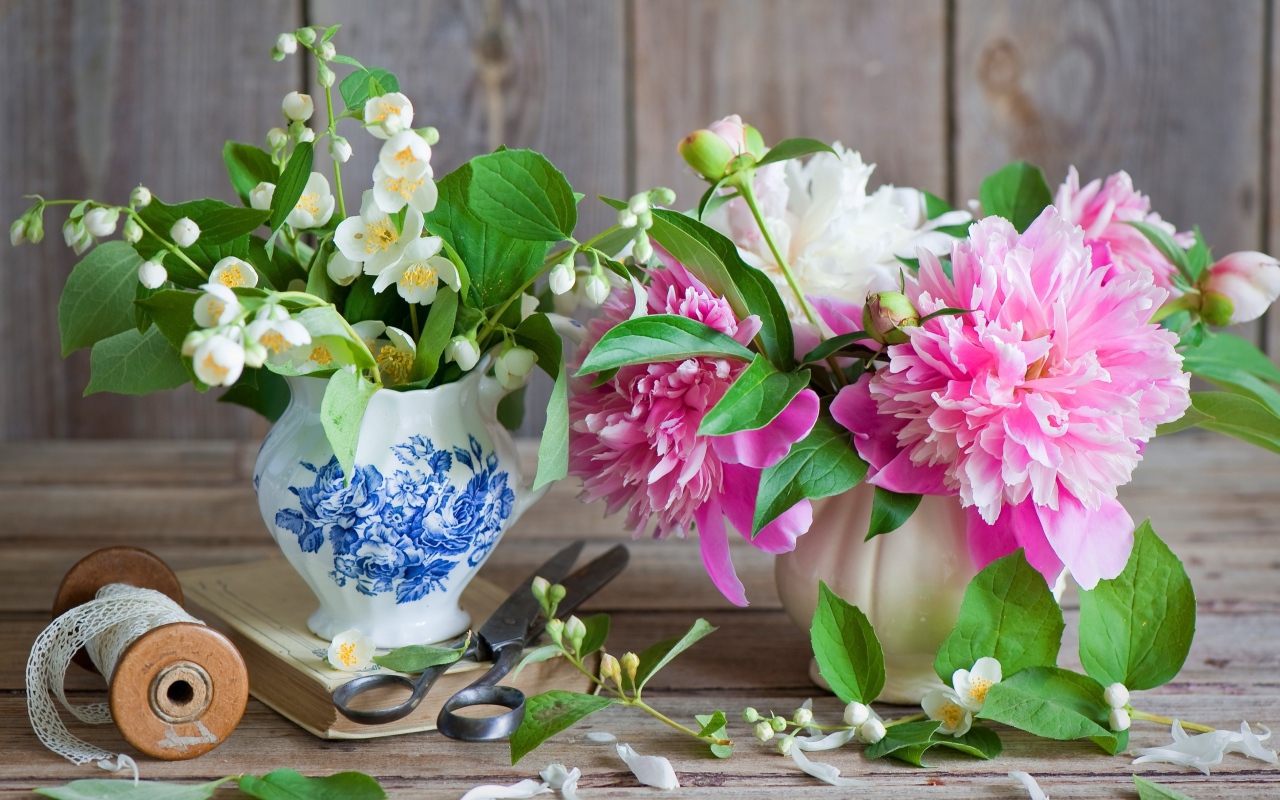 Нежные цветы жасмина и пионов в вазе на столе