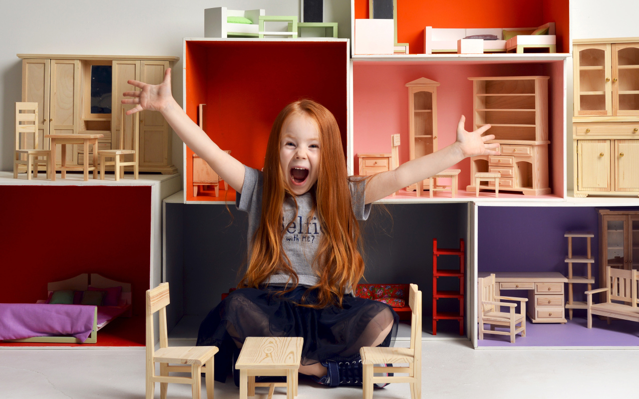 Маленькая девочка с игрушечной мебелью