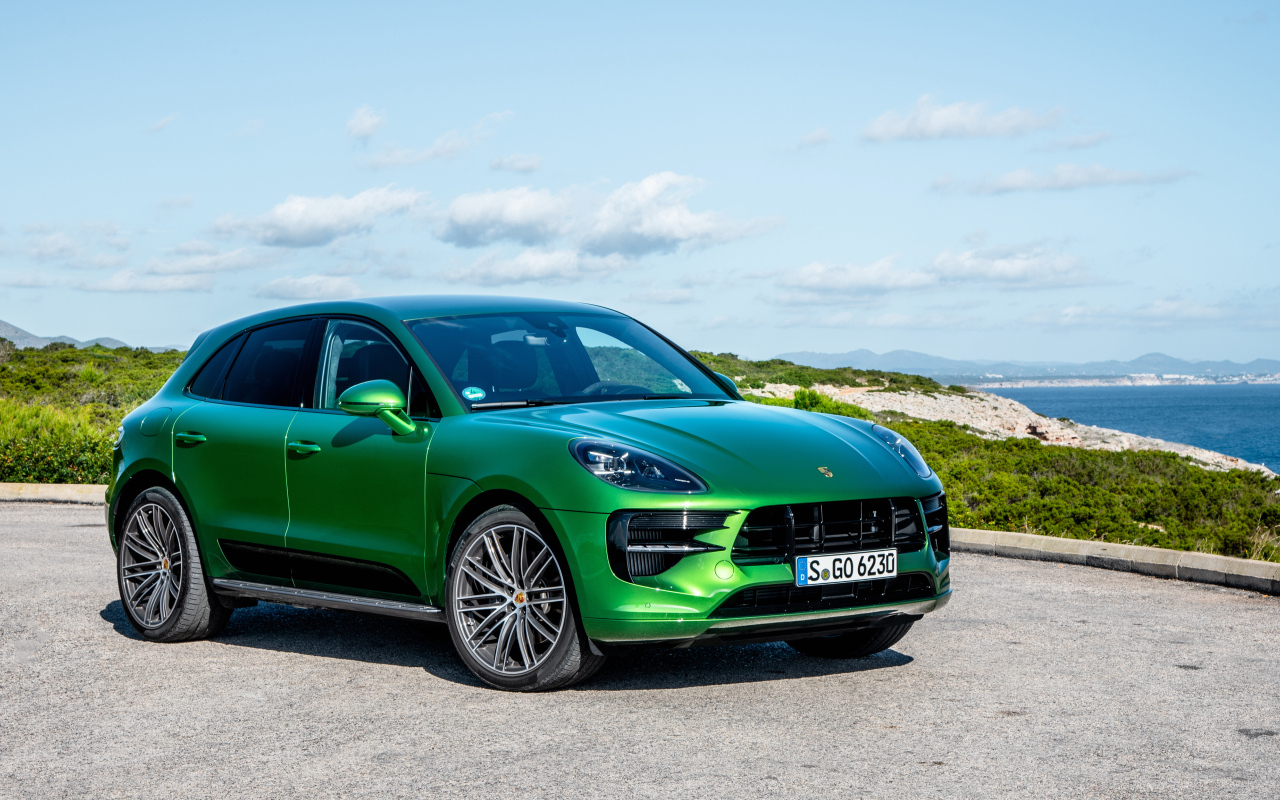 Зеленый внедорожник Porsche Macan S,  2018 года на фоне горизонта 