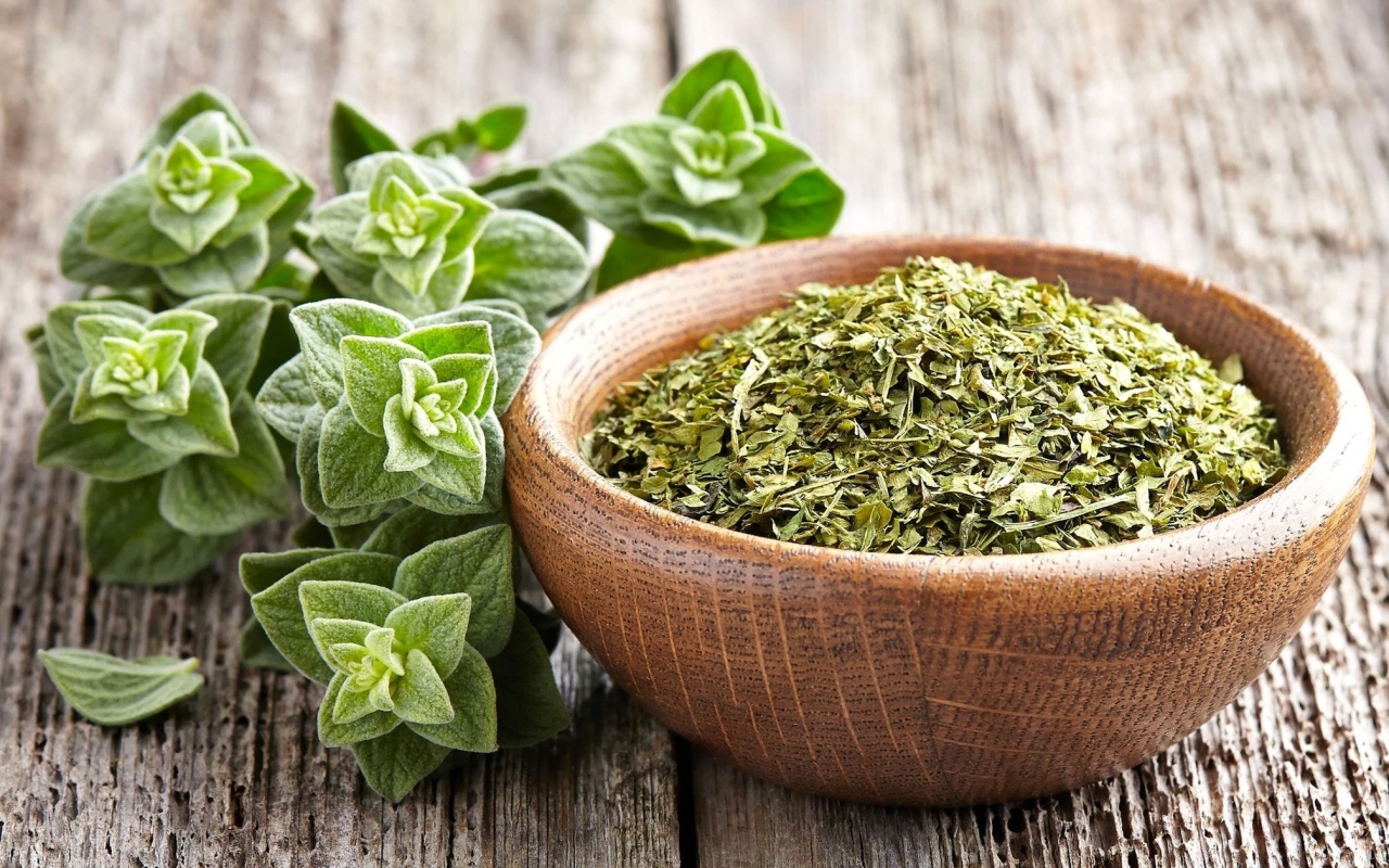 Dry oregano herb in a wooden bowl on the table