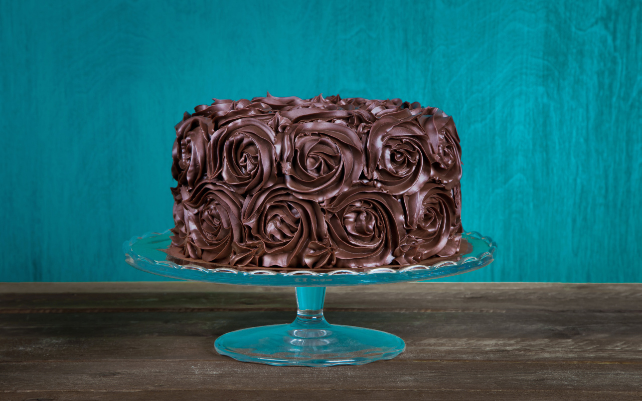 Шоколадный торт на стеклянном подносе на столе