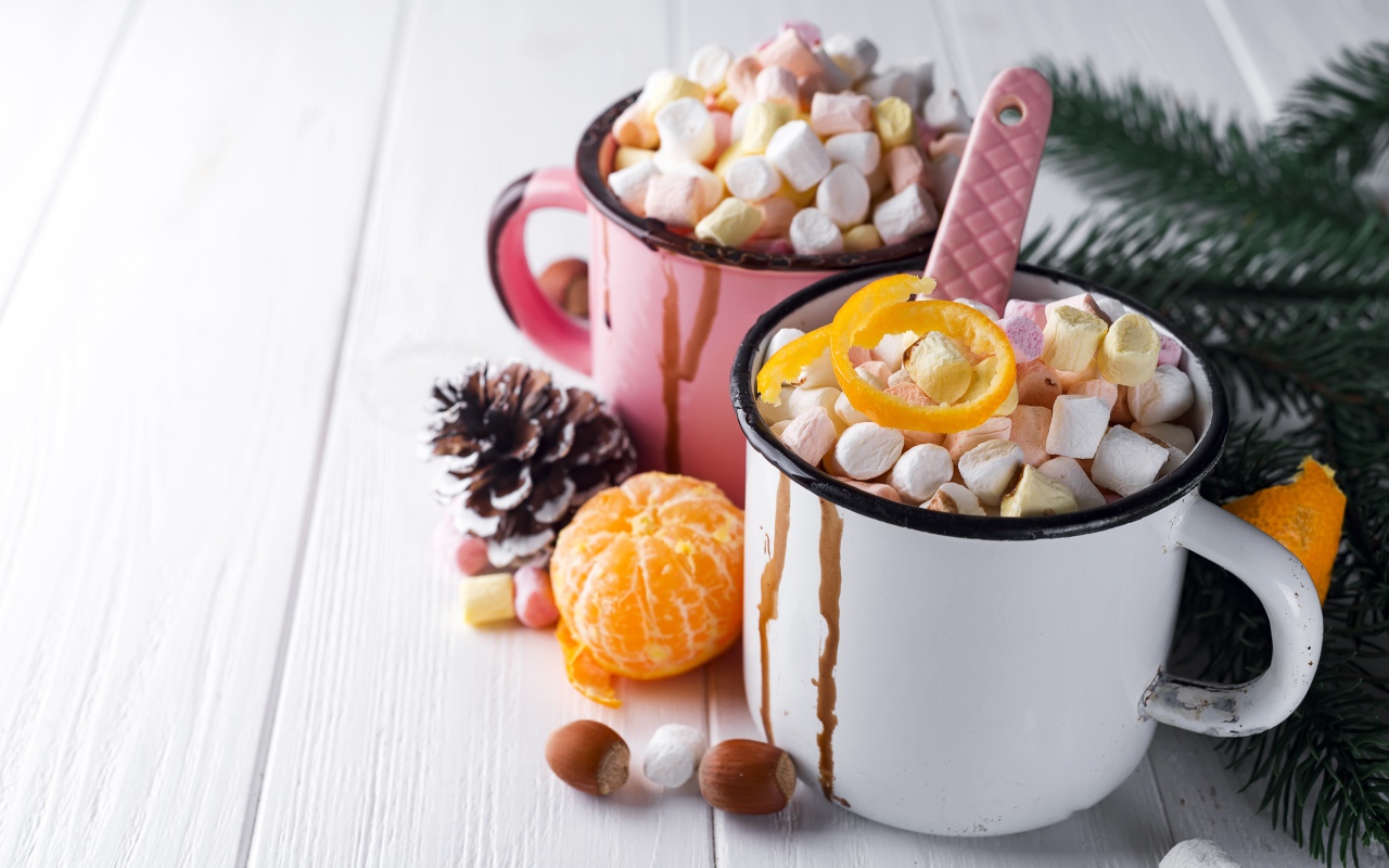 Две железные кружки с маршмеллоу на столе 