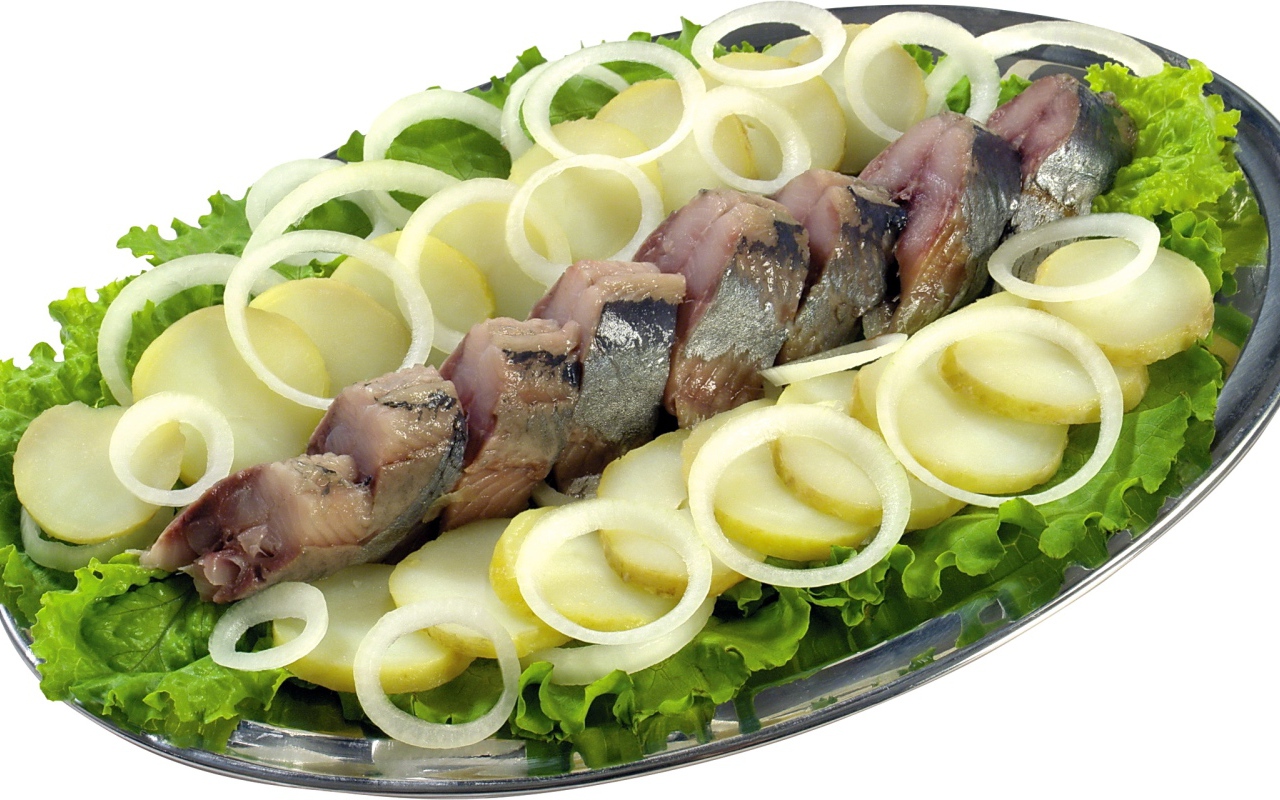 Herring with boiled potatoes, onions and lettuce on white background