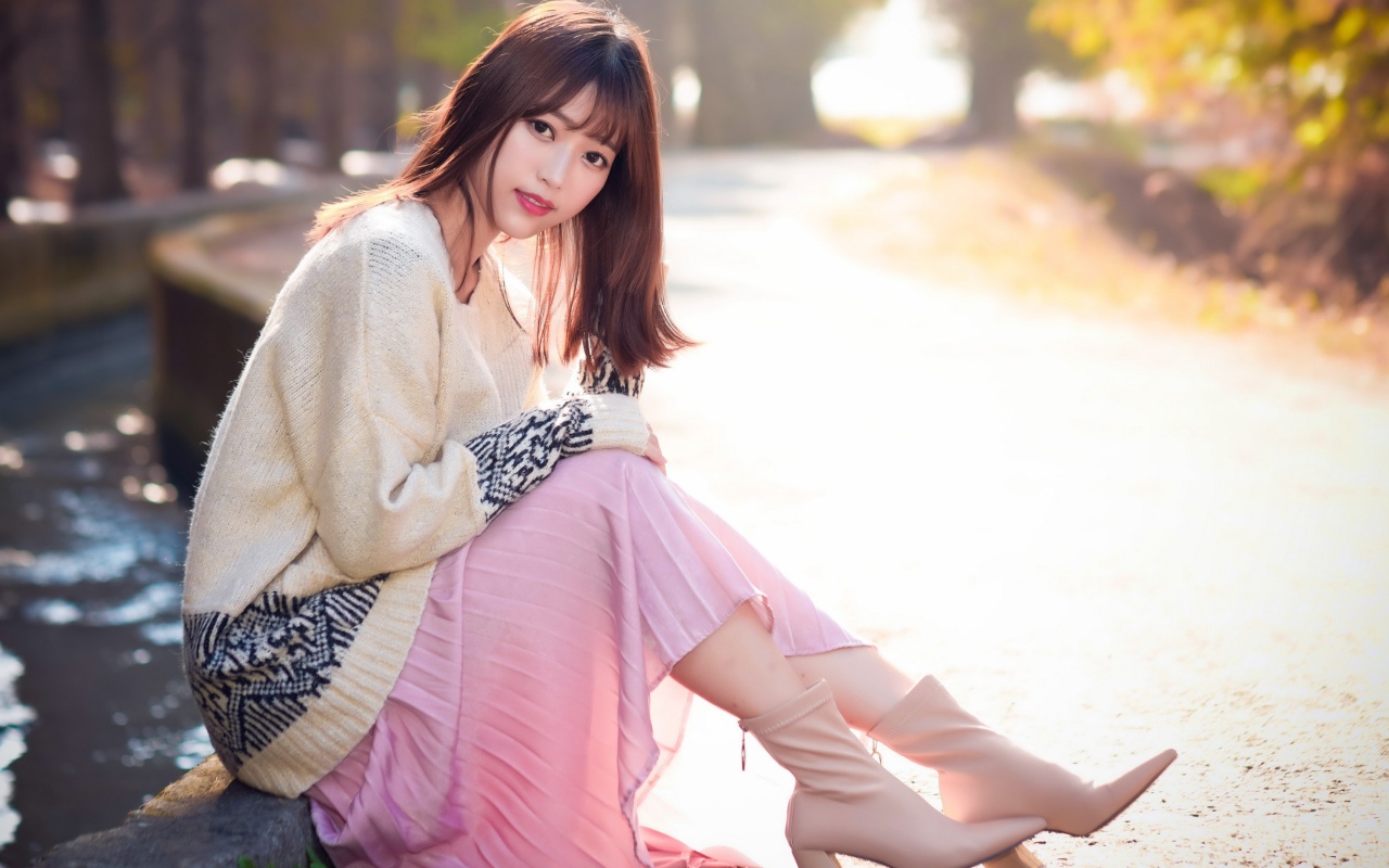 Девушка азиатка сидит на земле 