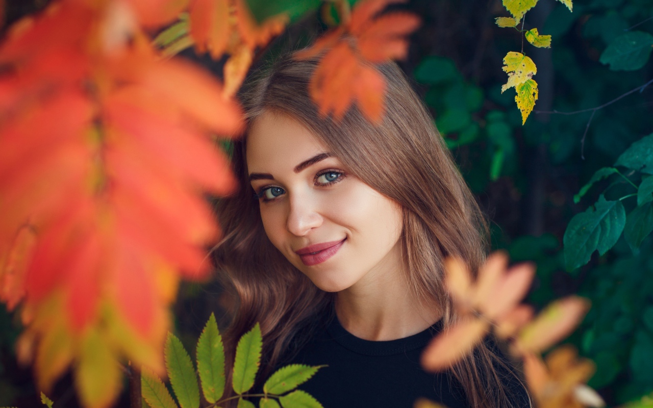 Красивая голубоглазая шатенка в листве