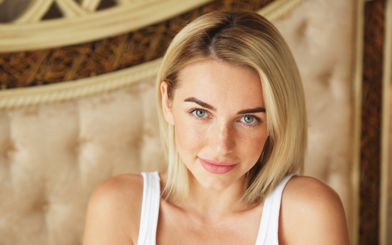 Нежная блондинка с зелеными глазами в белой майке