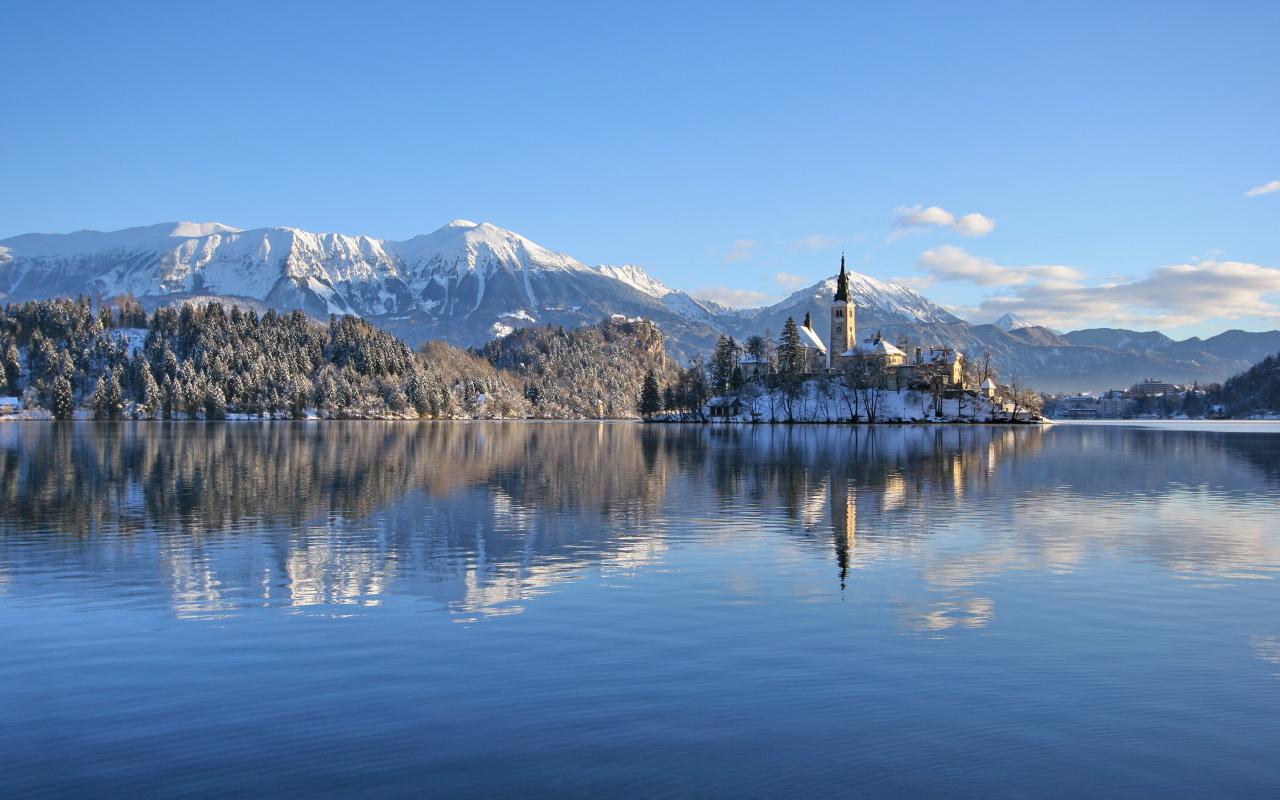 Beautiful view of the snow-capped mountains and the lake castle