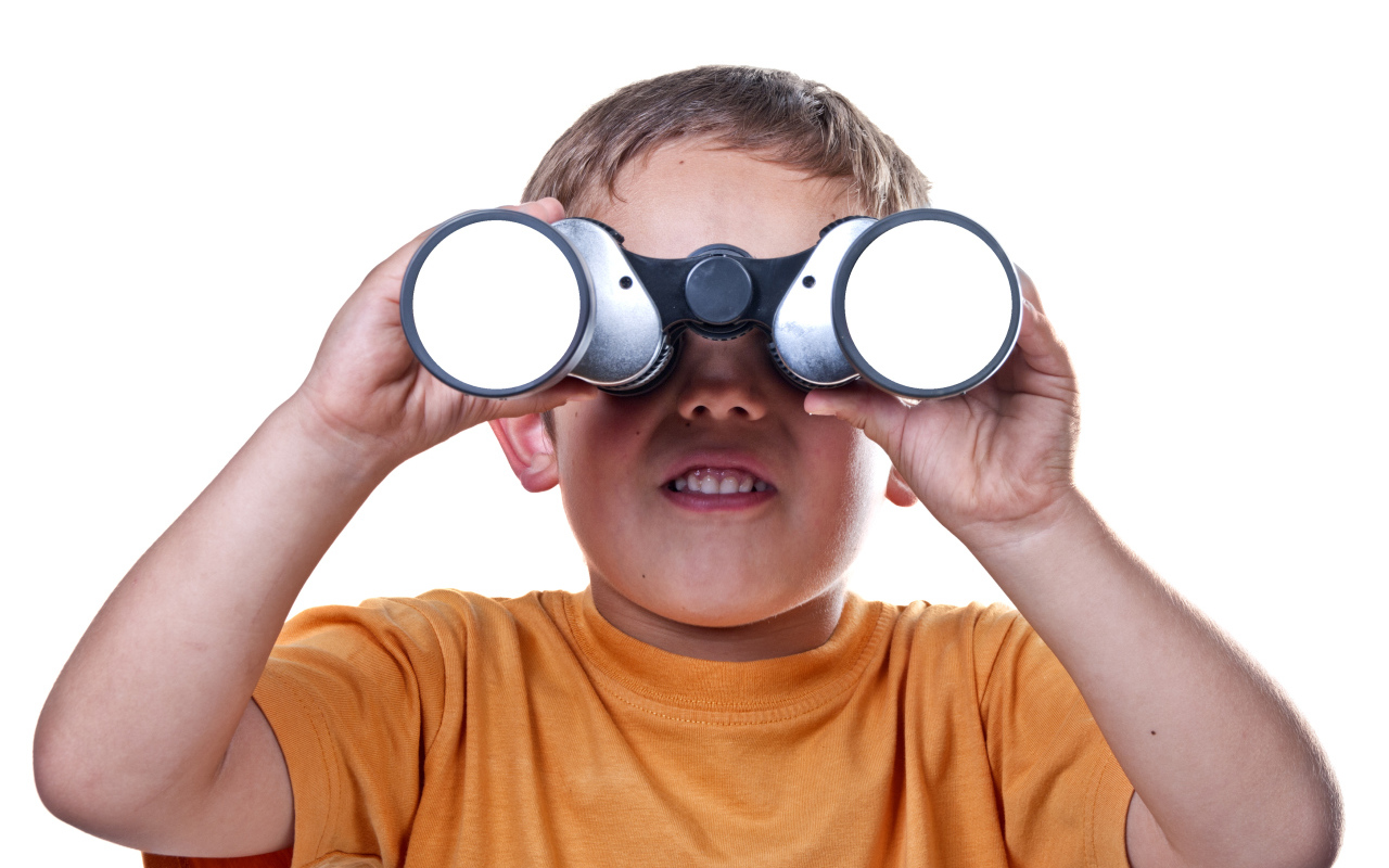 Little boy with binoculars on a white background