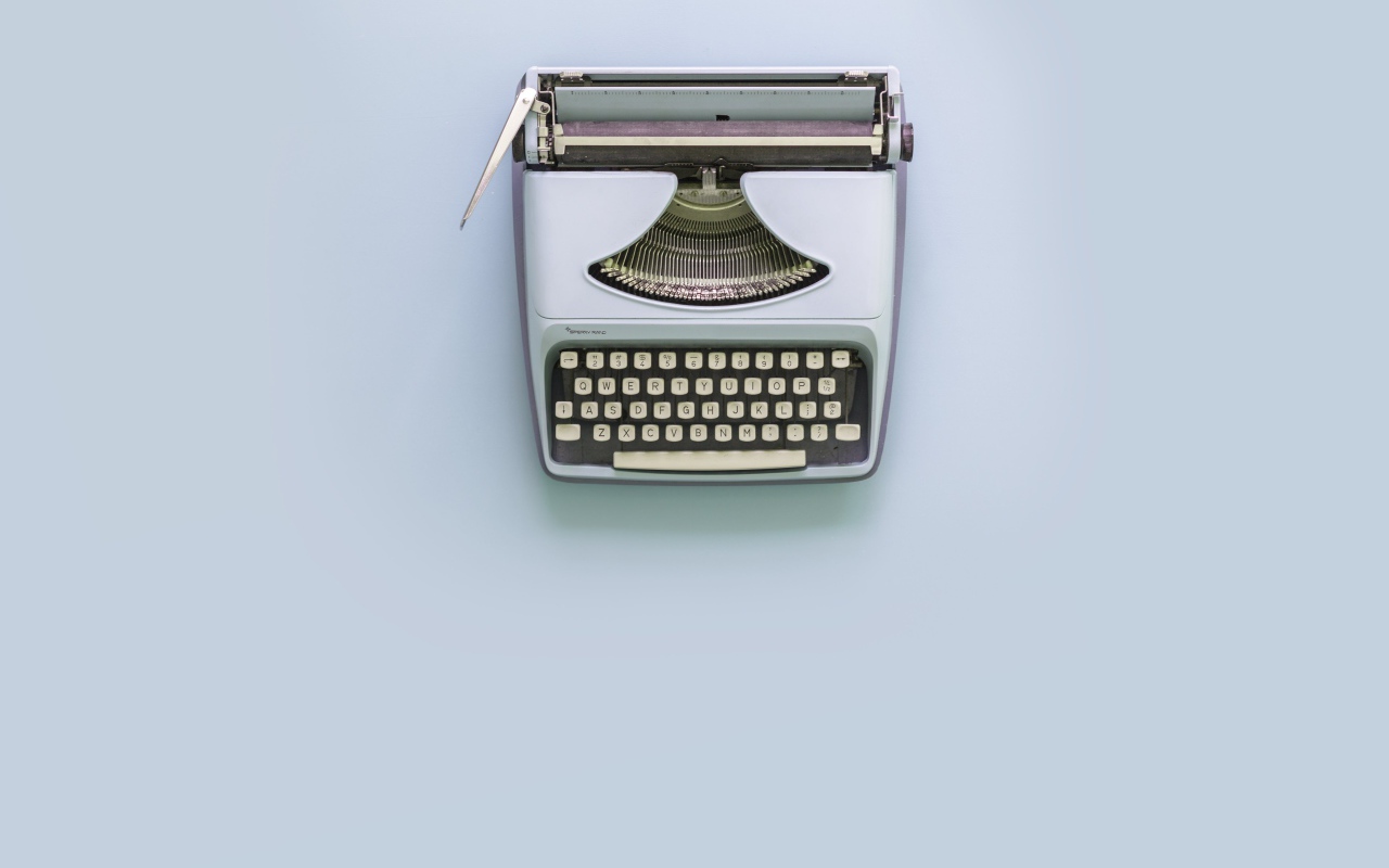 Old typewriter on gray background