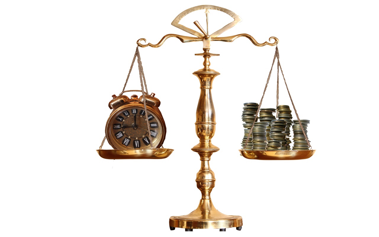 Scales with coins and watches on a white background