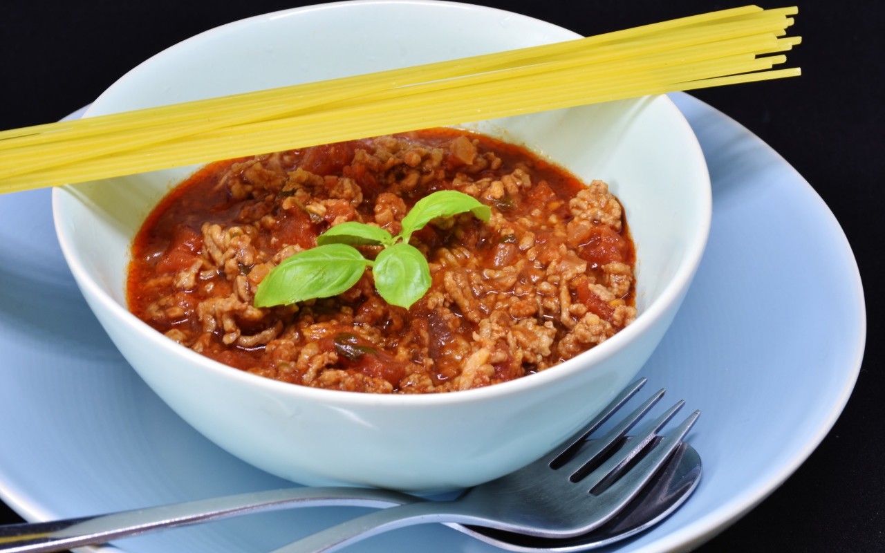 Спагетти с острым соусом с мясом на столе 