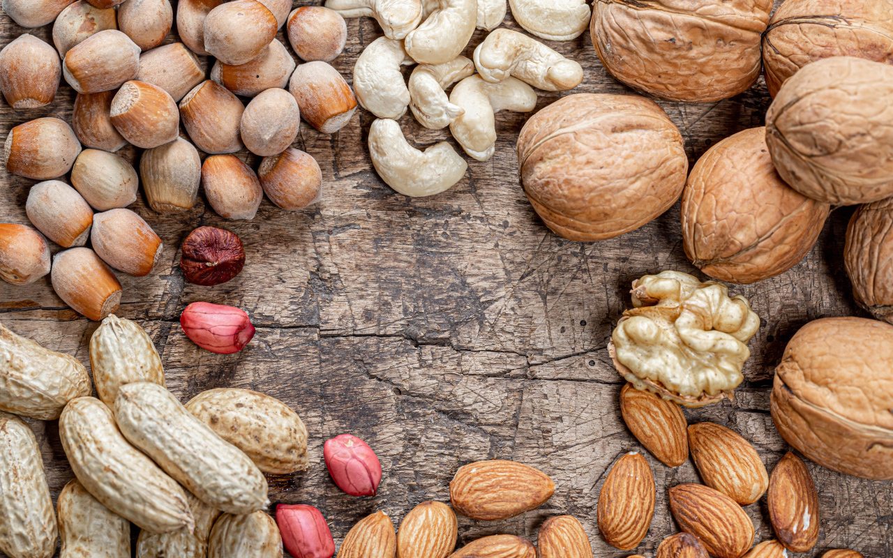 Много различных орехов на деревянном столе