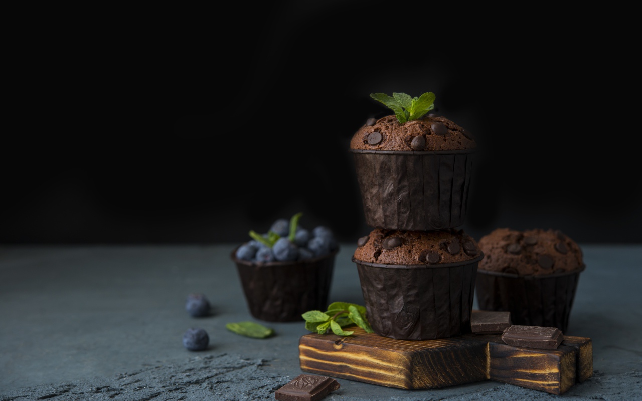 Кексы с шоколадом на столе с ягодами черники на столе 