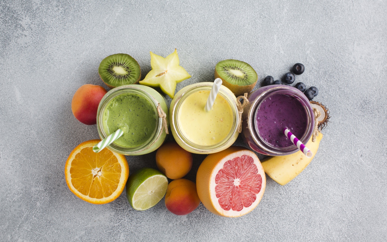 Смузи в банках на столе в ягодами и фруктами