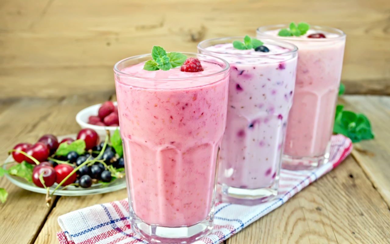 Three glasses of berry smoothie on the table