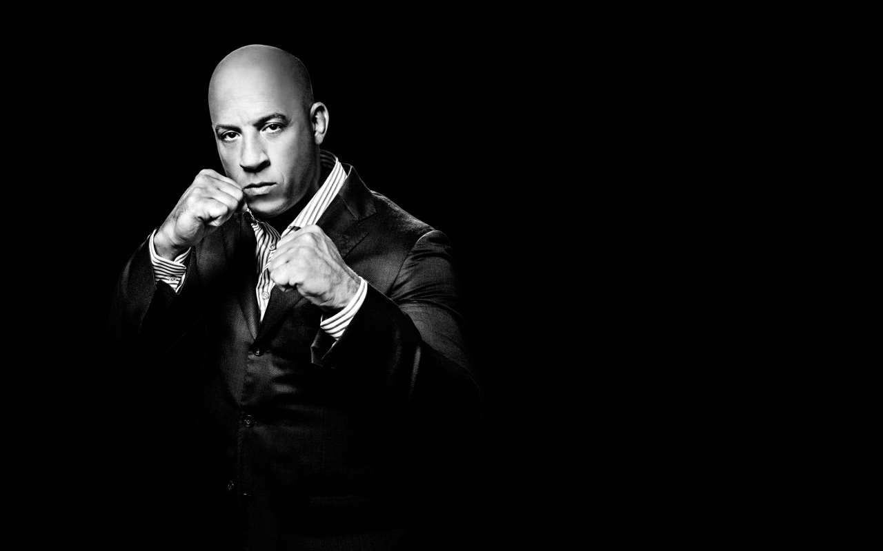 Popular actor Vin Diesel in a suit on a black background