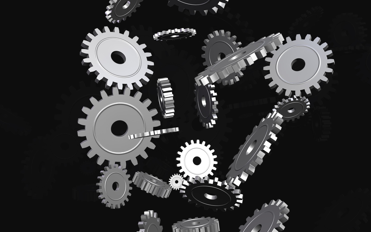Металлические шестеренки в воздухе на черном фоне