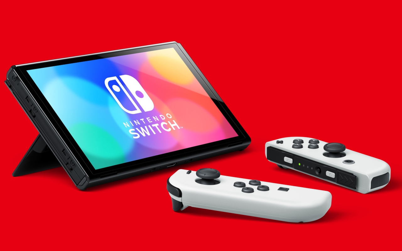 Nintendo Switch OLED game console on red background