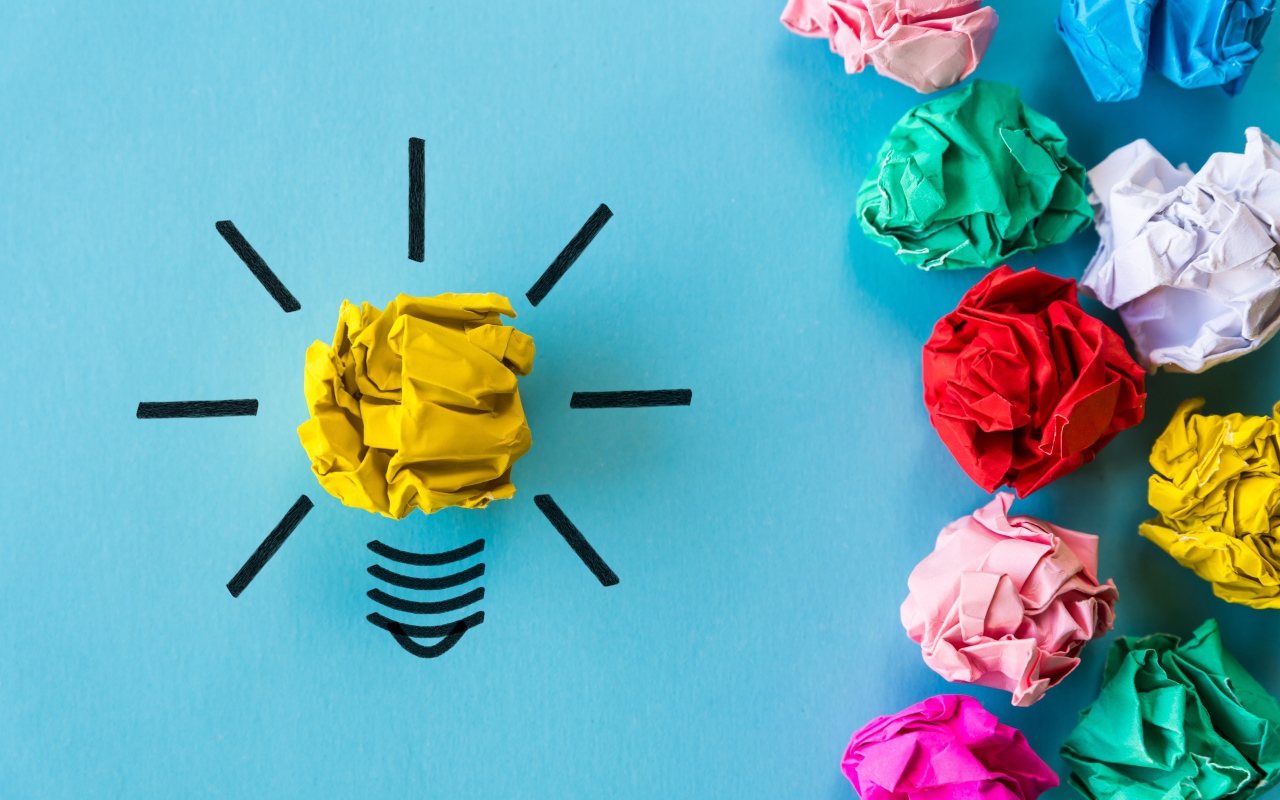 Комки разноцветной бумаги на голубом фоне 