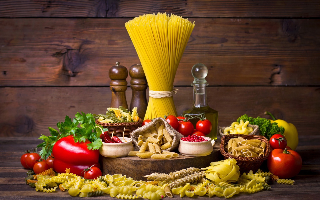 Много макаронных изделий на столе с овощами 