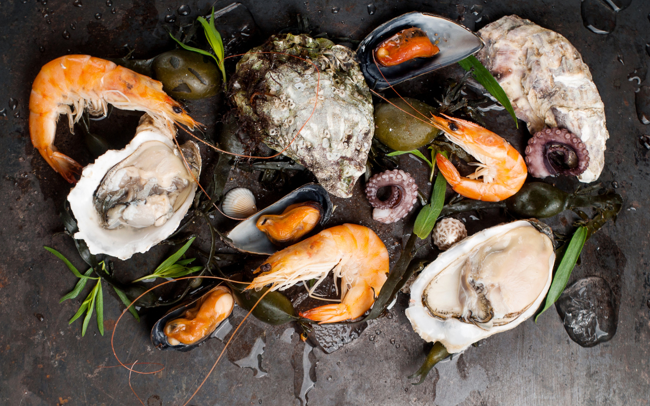 Мидии и креветки на черном столе 