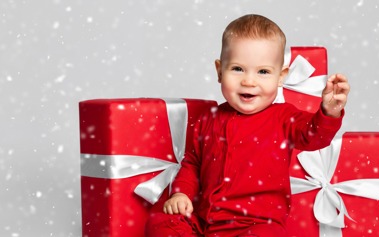 Smiling child with big red gifts