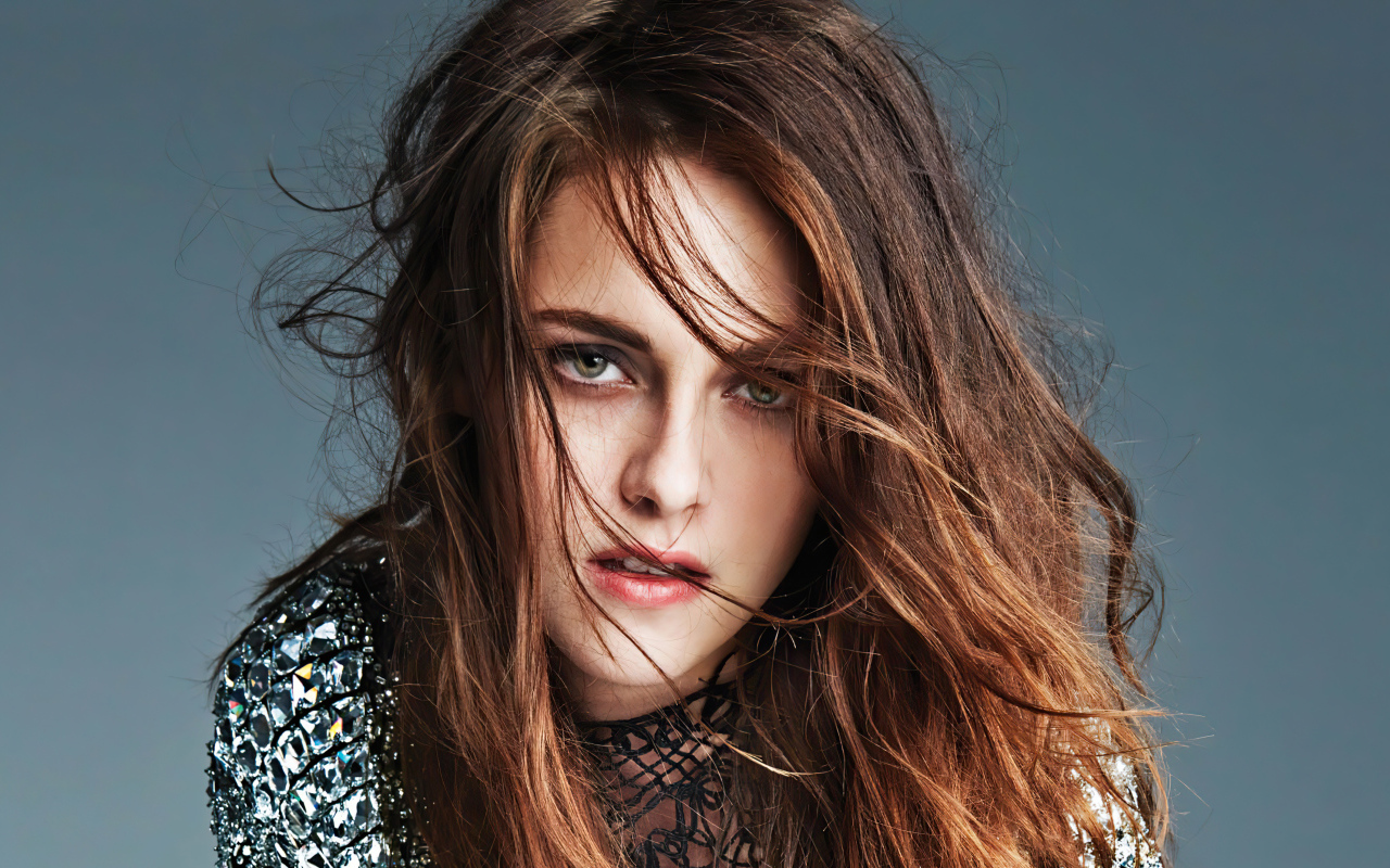 The face of actress Kristen Stewart on a gray background