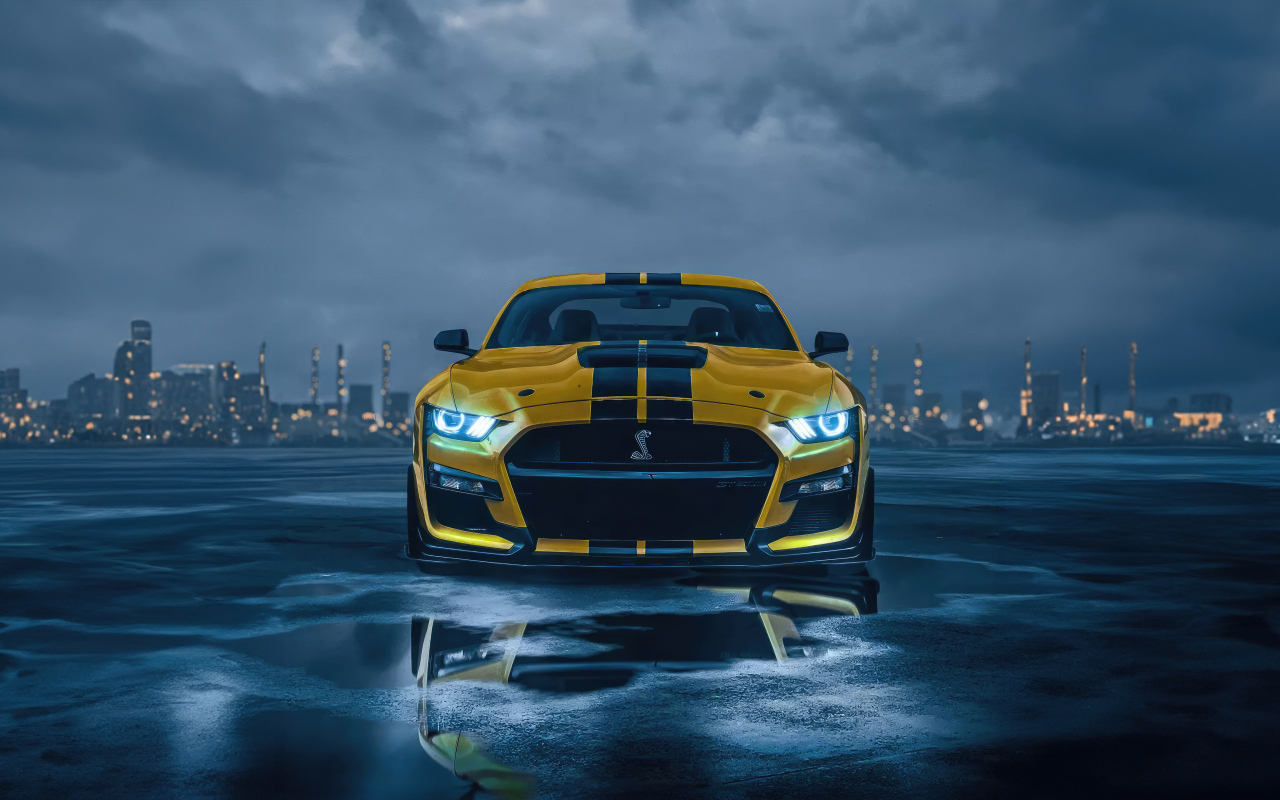 Желтый спортивный автомобиль Ford Mustang на фоне грозового неба