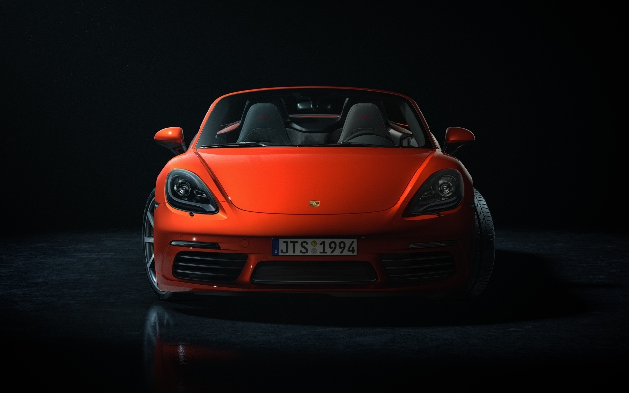 Красный автомобиль Porsche 911 CGI  вид спереди на черном фоне