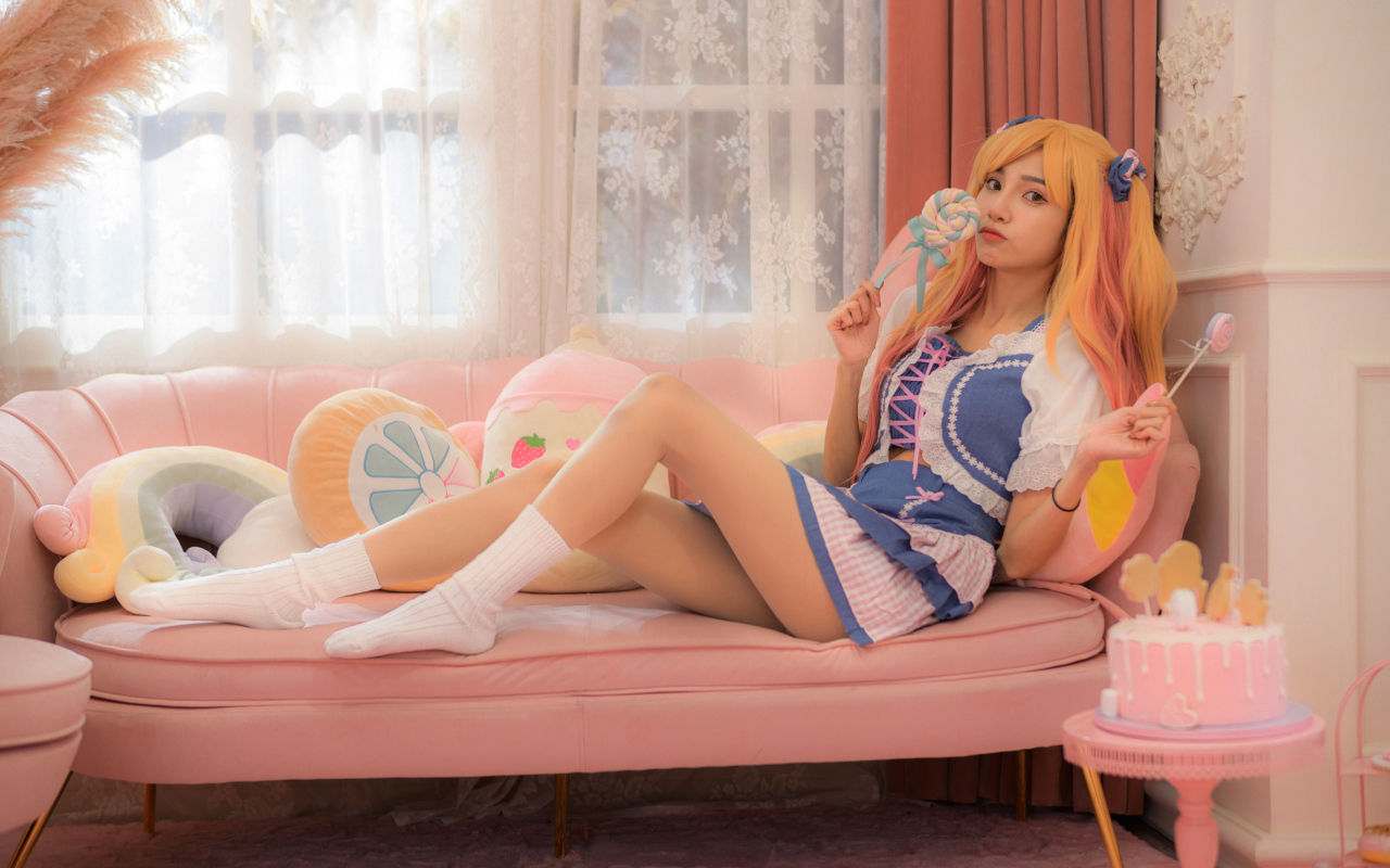 Девушка азиатка в костюме на диване 