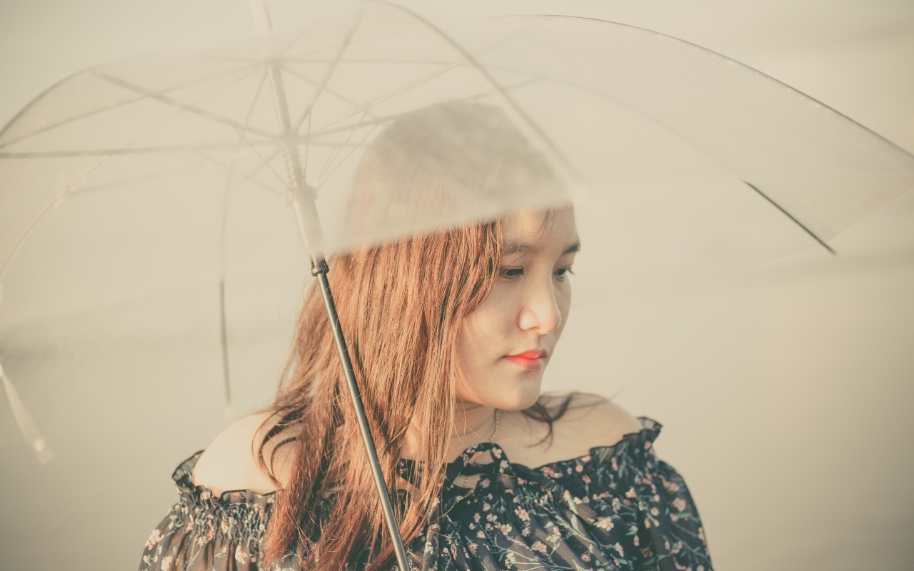 Девушка азиатка под прозрачным зонтом