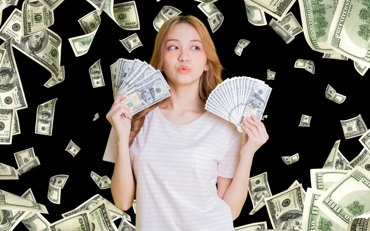 Девушка азиатка с долларами в руках