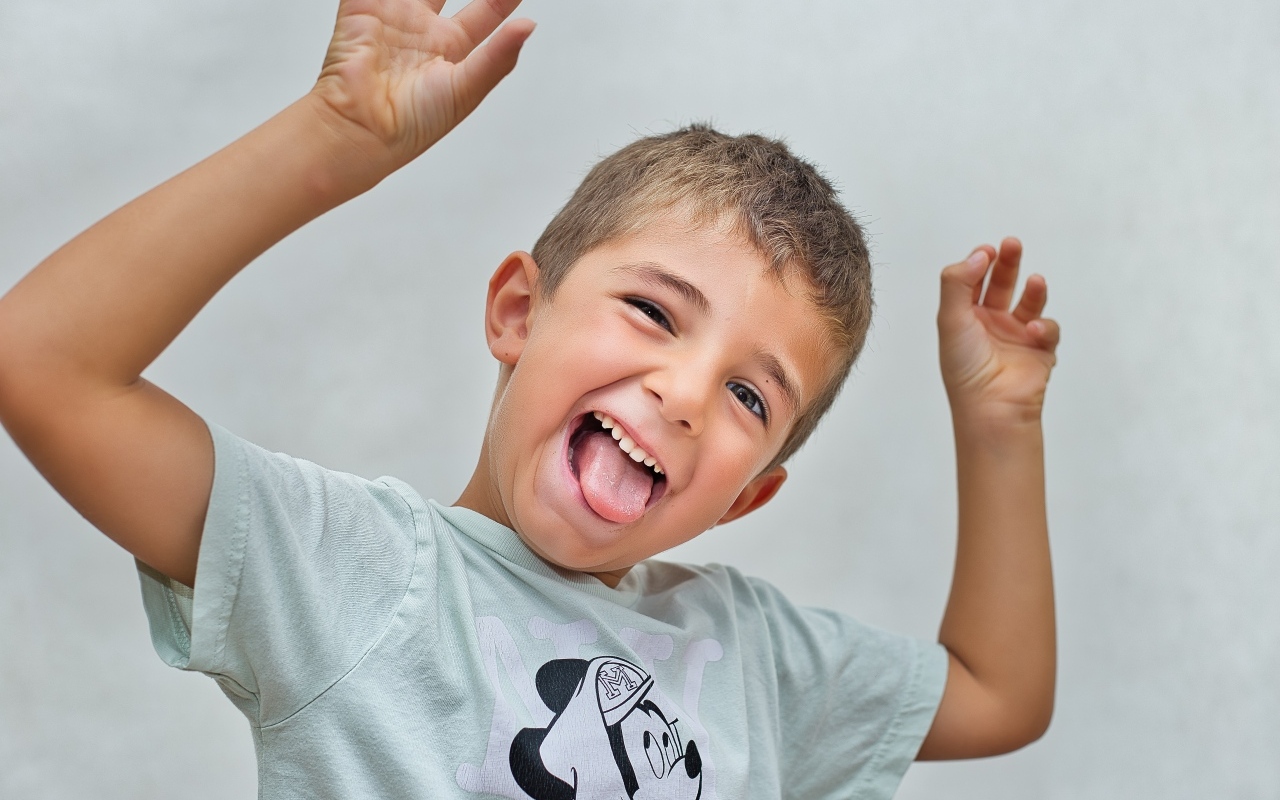 Смешной мальчик высунул язык