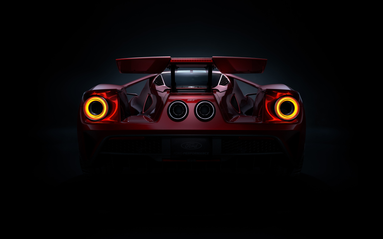 Вид сзади на автомобиль Ford GT  на черном фоне