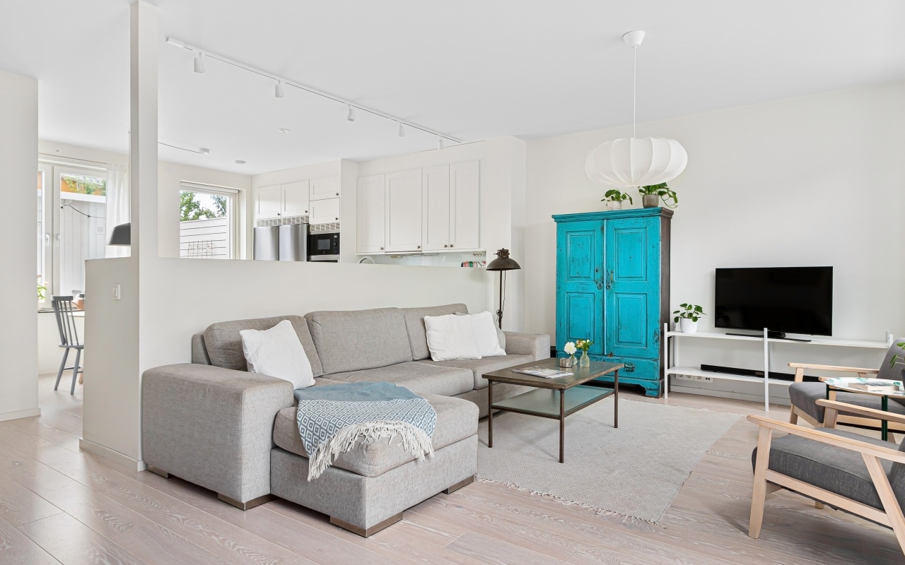 Просторная гостиная комната  с серым диваном