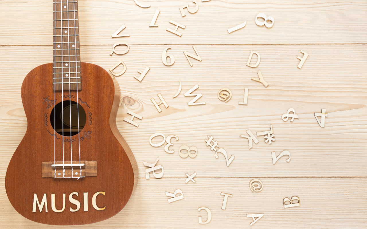 Гитара с буквами на деревянном фоне