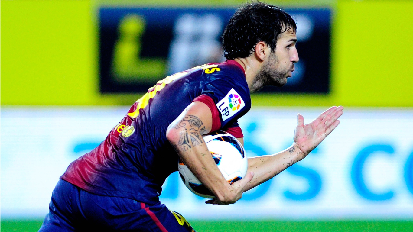 The player of Barcelona Francesc Fabregas runs with a ball