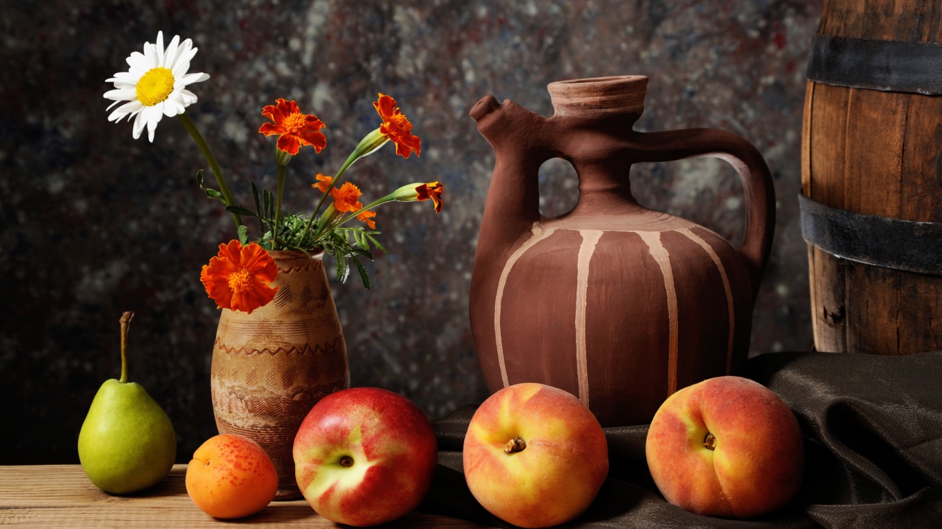 Fruit and a vase of flowers