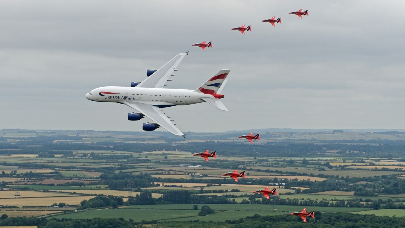 Airbus A380 в сопровождении красных истребителей