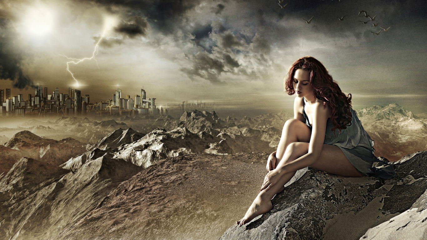 Девушка сидит на камне за городом