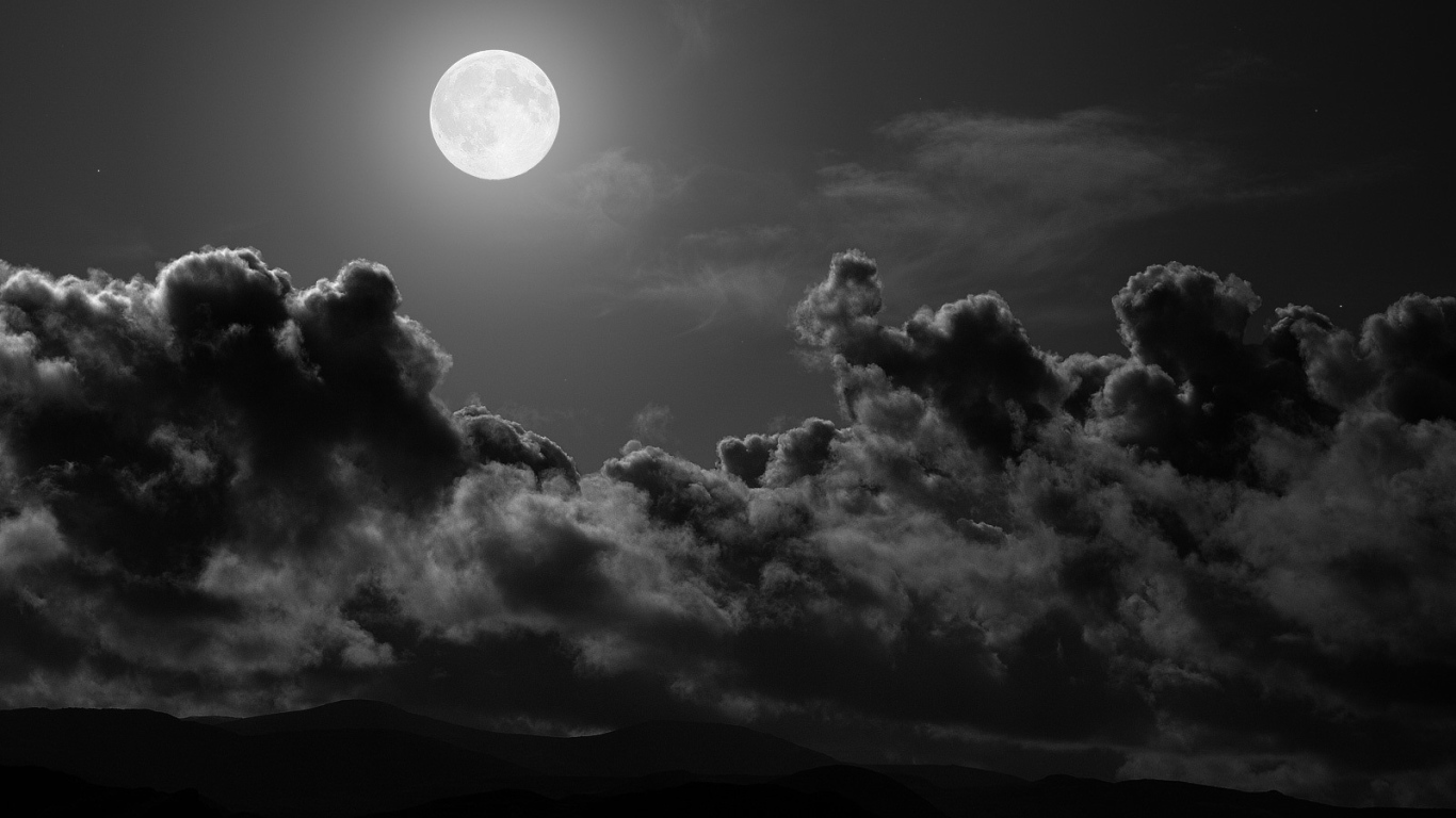 	   The moon over the dark clouds