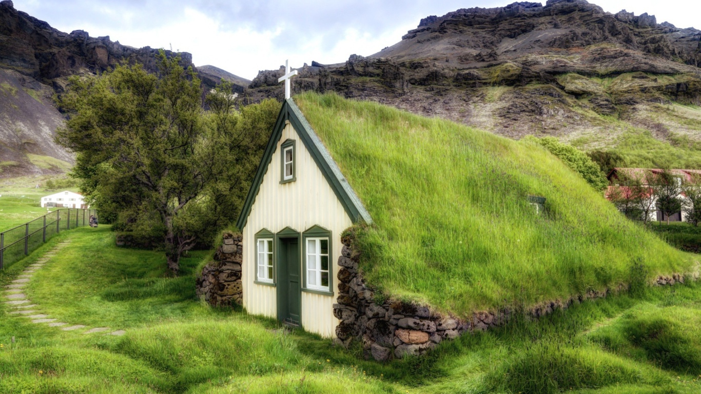 Поросшая травой крыша церкви в горной деревушке