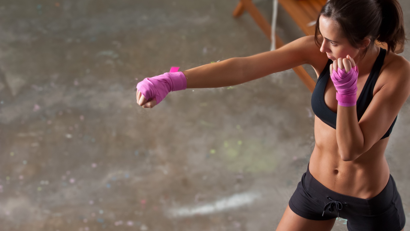 Girl boxer trains in the gym