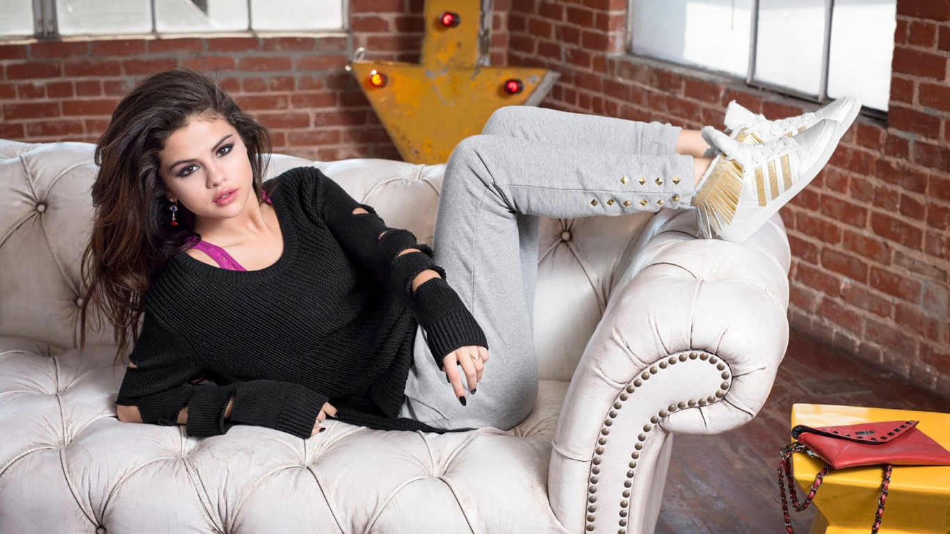 Selena Gomez on a white leather couch