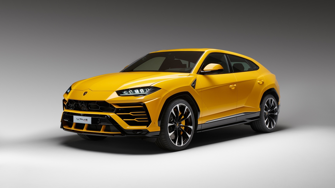 Желтый спортивный автомобиль Lamborghini Urus, 2018 на сером фоне