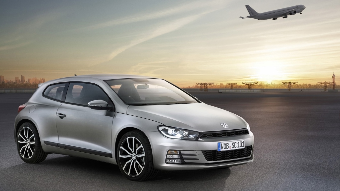 Серебристый Volkswagen Scirocco 2017 года на фоне взлетной полосы 