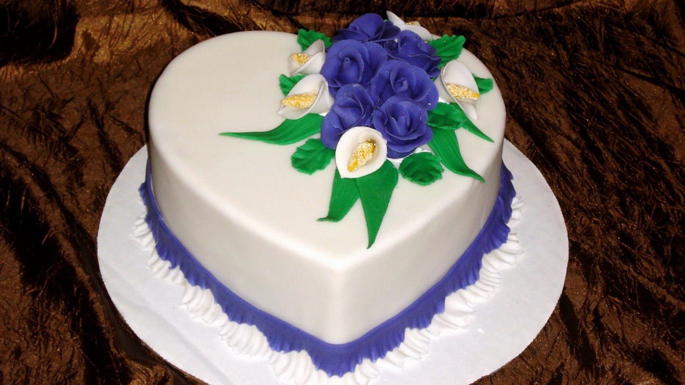 Красивый торт в форме сердца украшен цветами