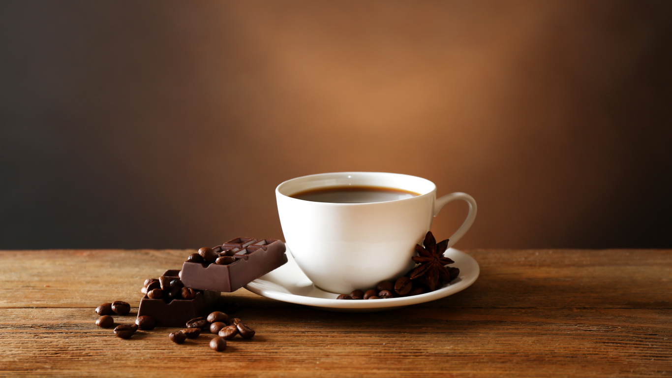 Кофе в белой чашке с черным шоколадом