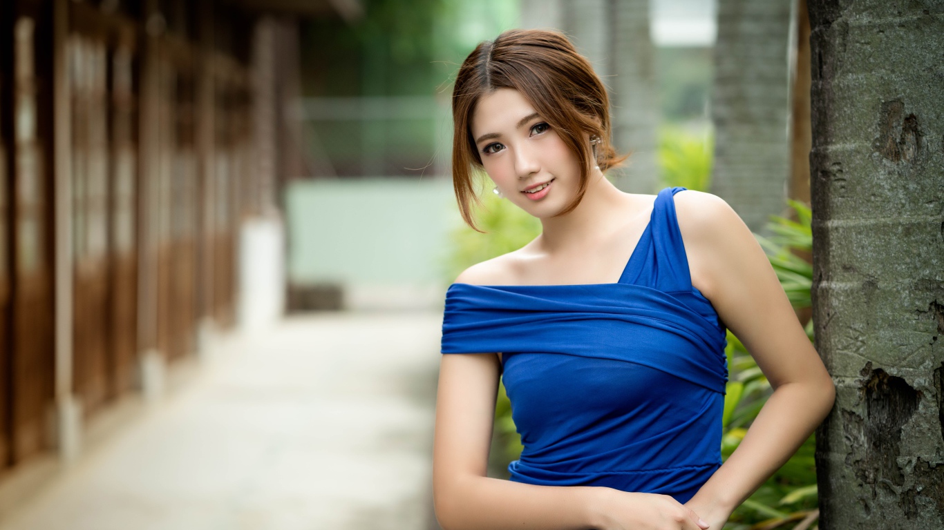 Молодая девушка азиатка в красивом голубом платье