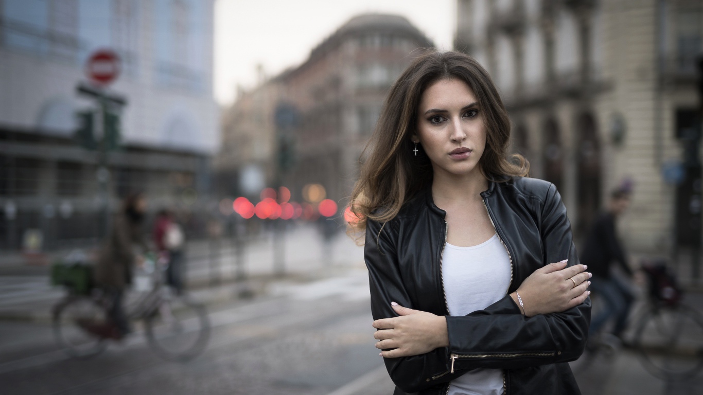 Молодая брюнетка в черной кожаной куртке